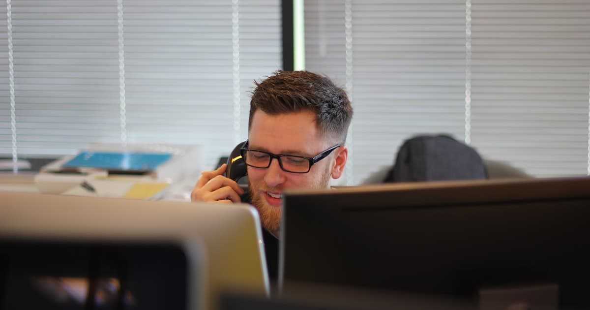 man using IP phone inside room